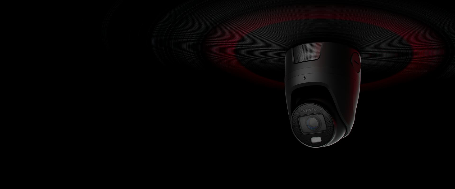 Ajax TurretCam security camera glowing red in low light